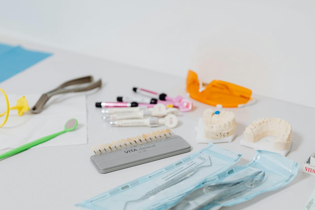 Close-up of various dental tools and models used for dentistry displayed on a table.