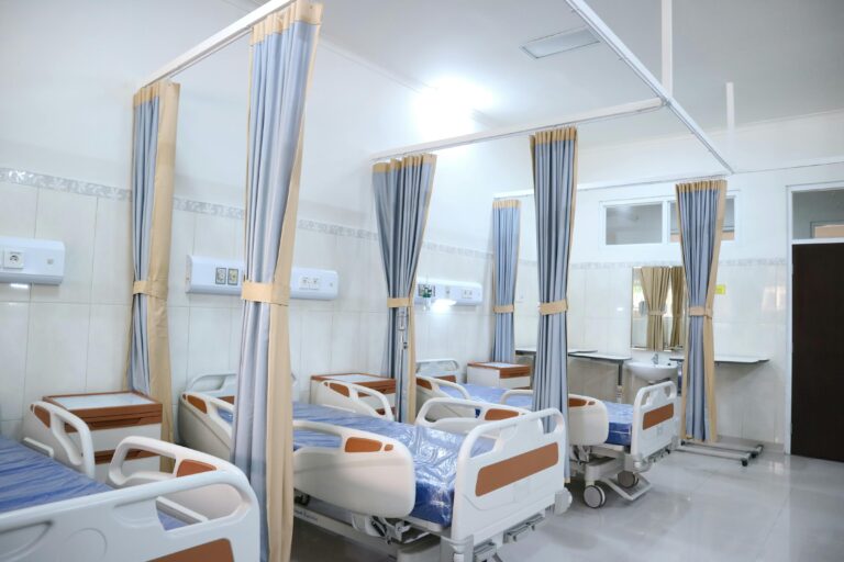 Spacious hospital ward with modern equipment and private patient areas.